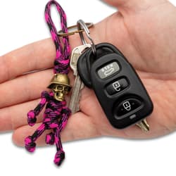 Full image of the Keychain hooked on a set of keys held in hand.